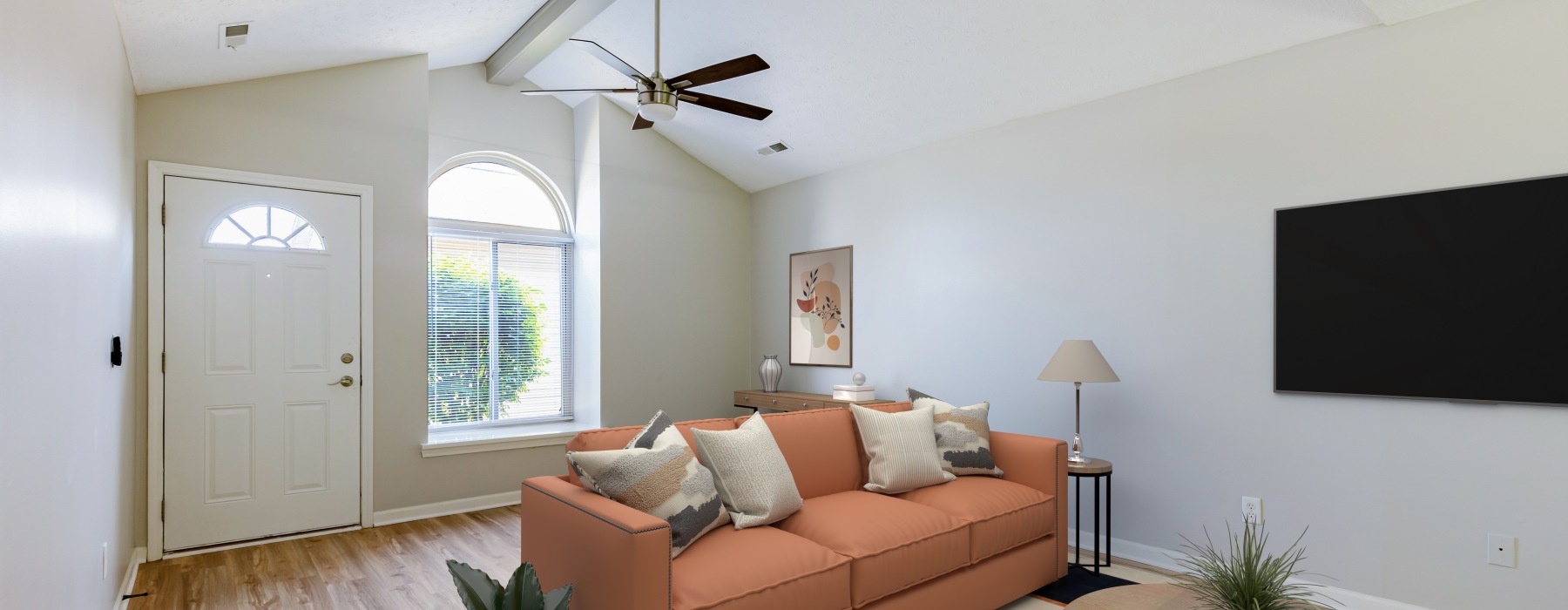 Styled apartment living room with vaulted ceilng