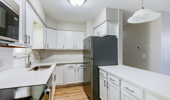Kitchen with white cabinets and stainless steel appliances