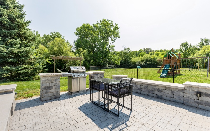 Paved area with grill and dining set