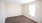 a room with a carpet and a light on the ceiling