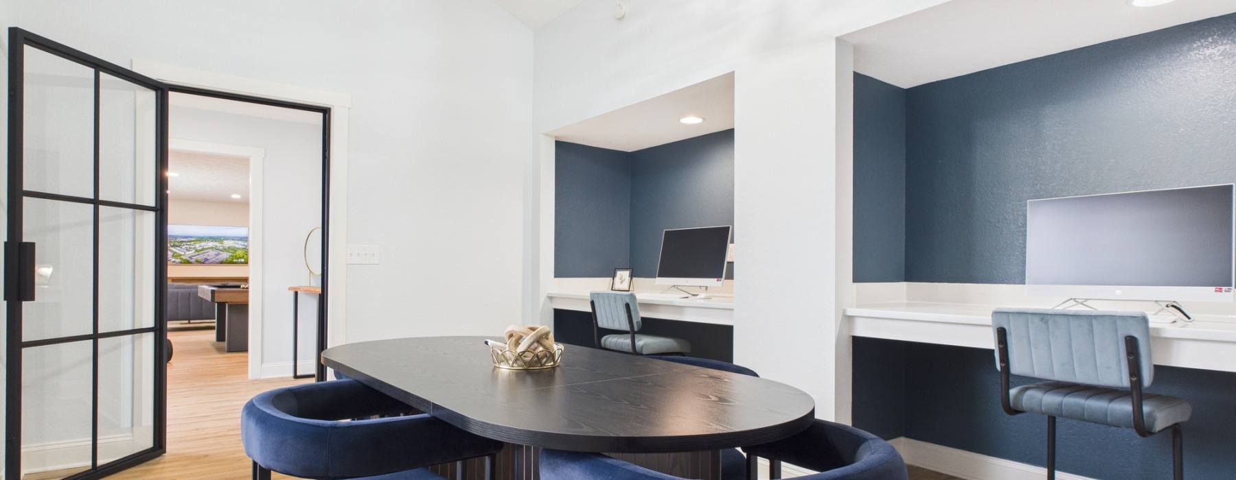 Room with computer, tables, and tv