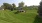 a large green lawn with fenced dog park