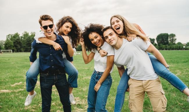 friends posing for a photo on a soccer field