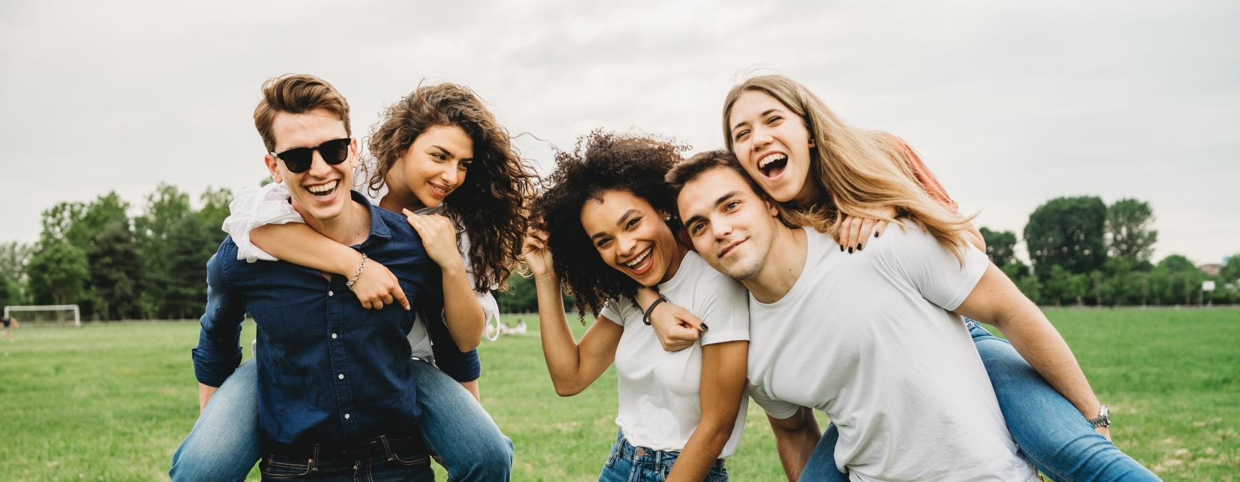 friends posing for a photo on a soccer field