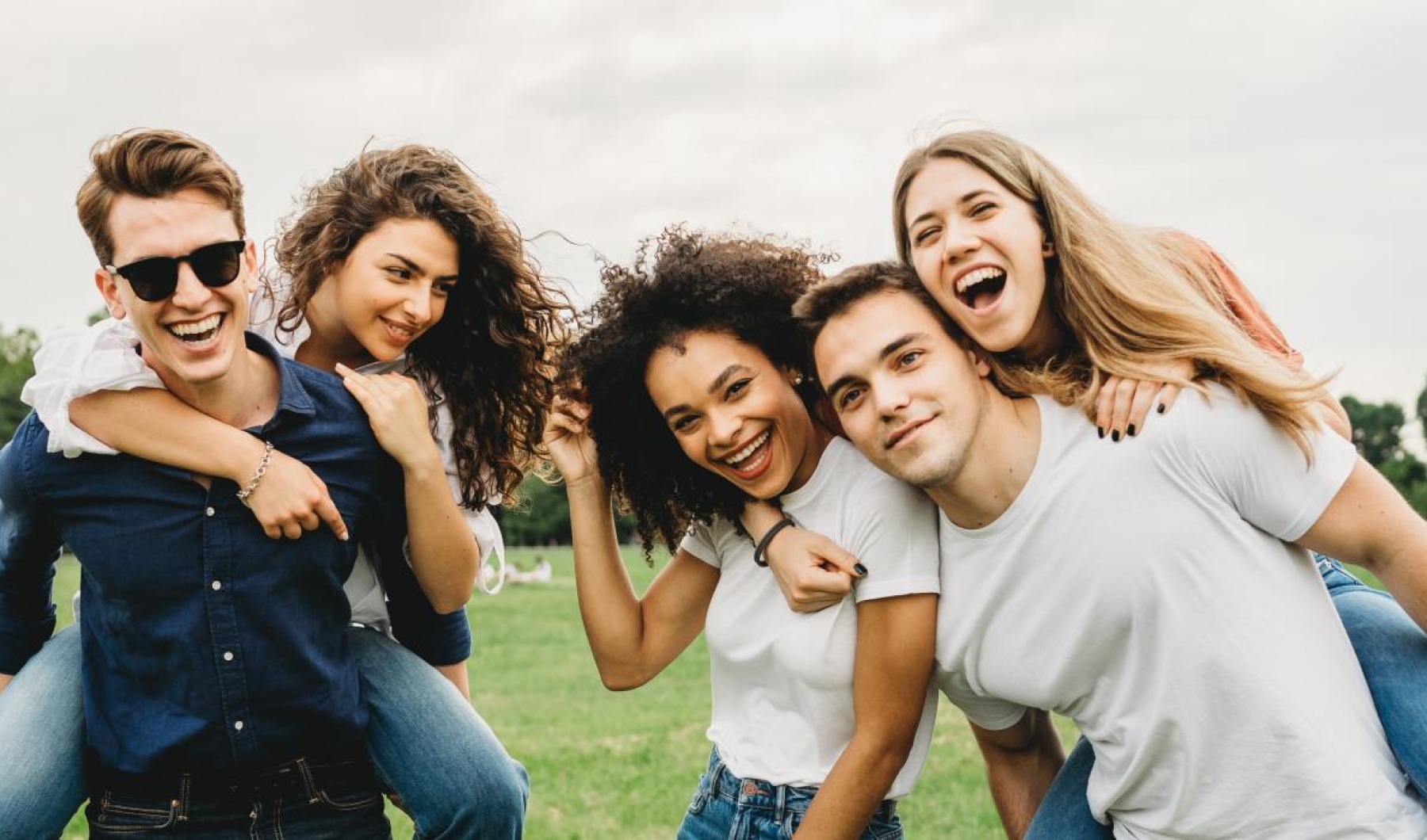 friends posing for a photo on a soccer field