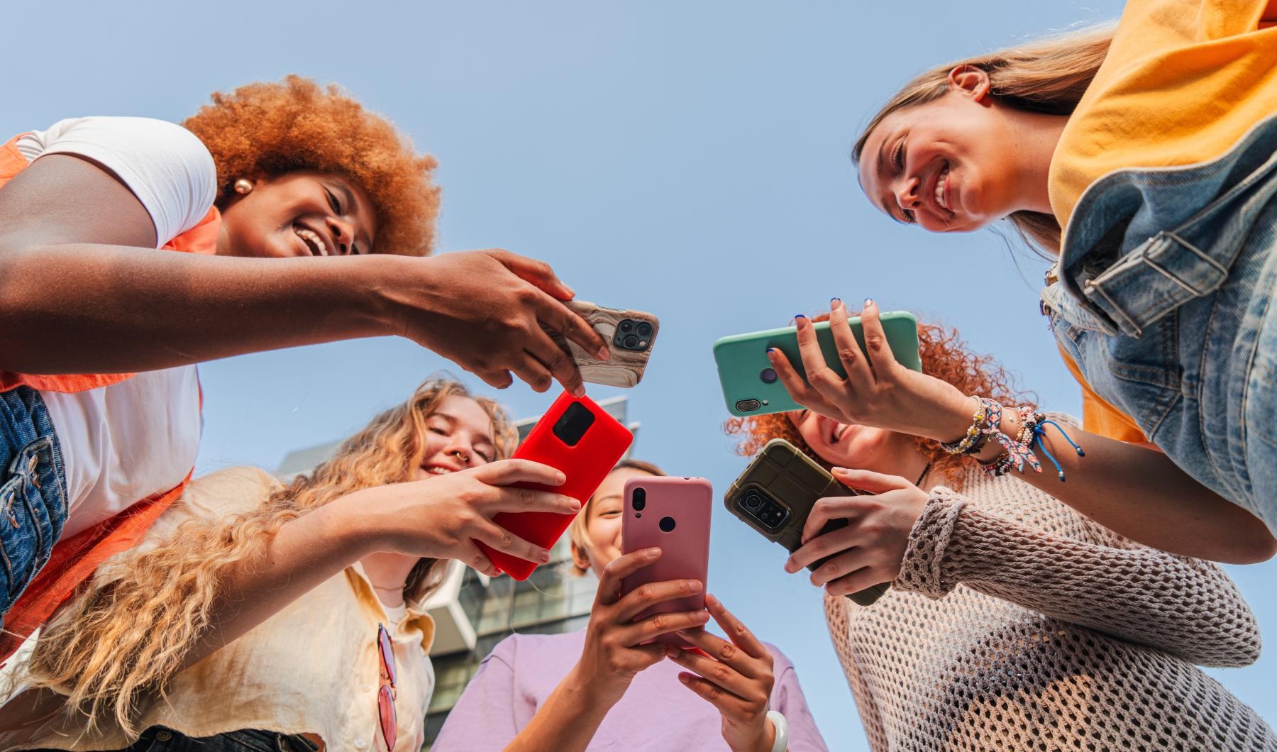 a group of people holding cell phones