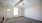 living room with a ceiling fan and a door