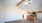 carpeted living room open to kitchen
